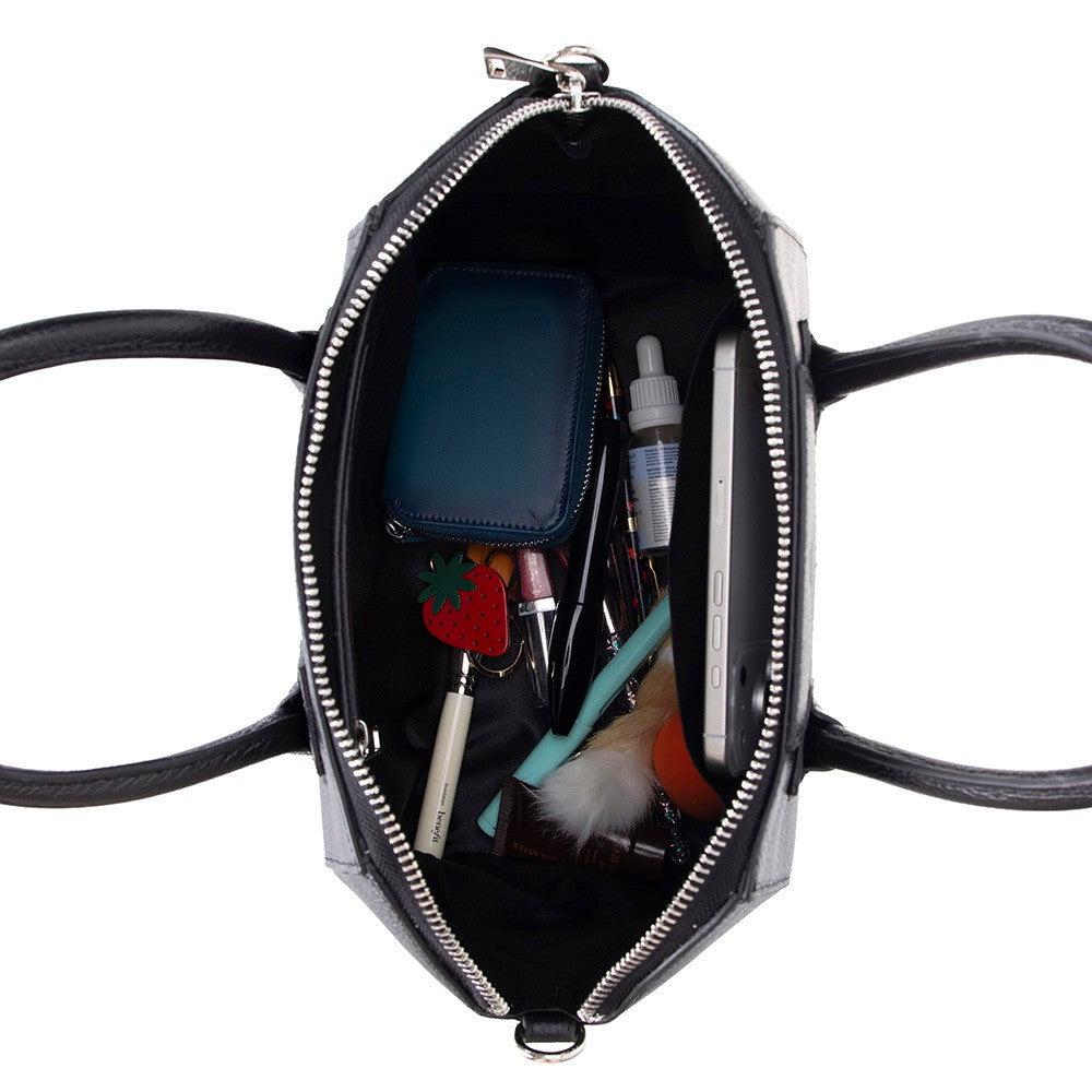Interior of the SYSL black leather handbag with daily essentials